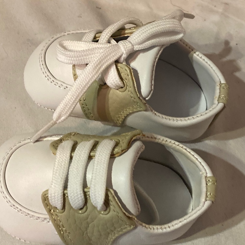 Designers Touch 6 weeks to three months.  tan and white leather baby shoes.